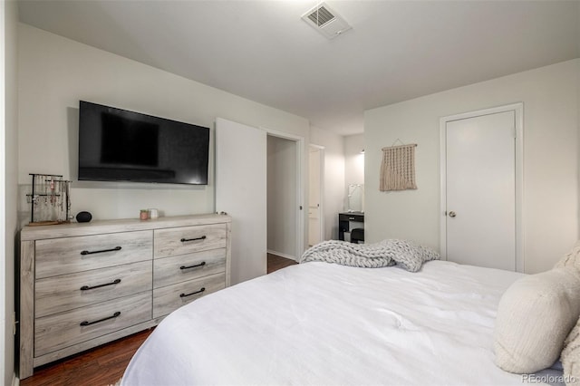 bedroom with dark wood finished floors and visible vents