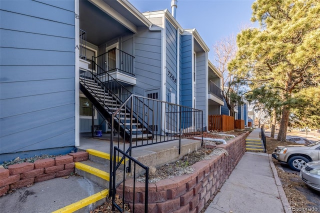 view of side of property with stairway