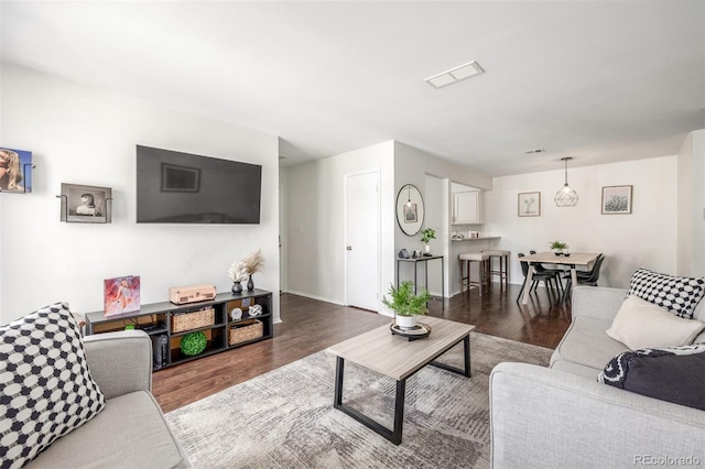 living room with wood finished floors and visible vents