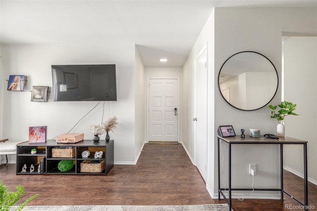 foyer with wood finished floors and baseboards