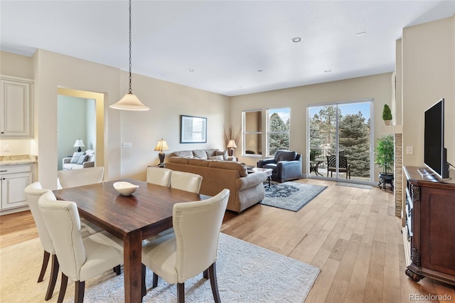 dining space featuring light wood finished floors