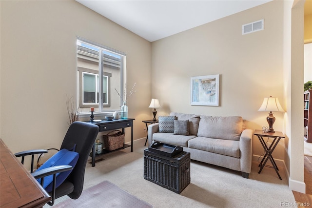 home office with carpet floors, visible vents, and baseboards