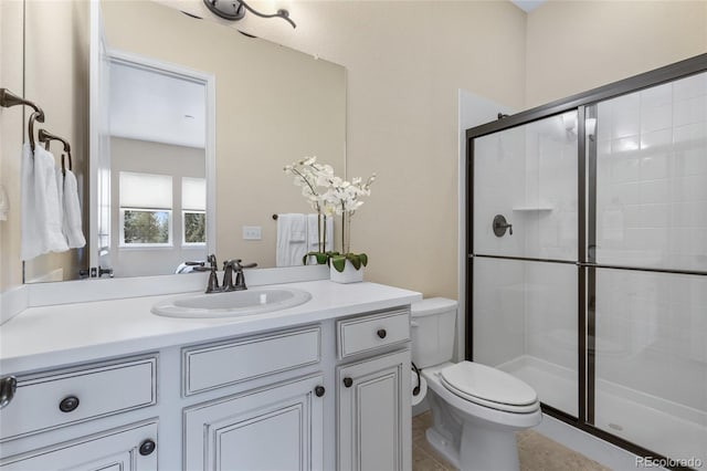 bathroom featuring toilet, tile patterned floors, a tile shower, and vanity