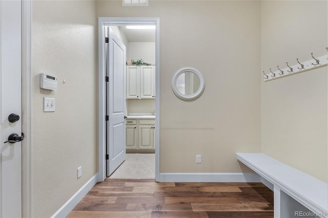 mudroom with visible vents, light wood-style flooring, and baseboards