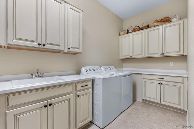 washroom featuring independent washer and dryer, a sink, and cabinet space