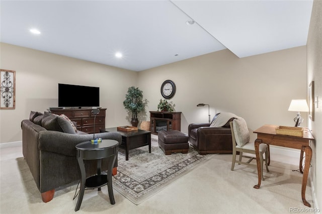 living room featuring recessed lighting, light colored carpet, and baseboards