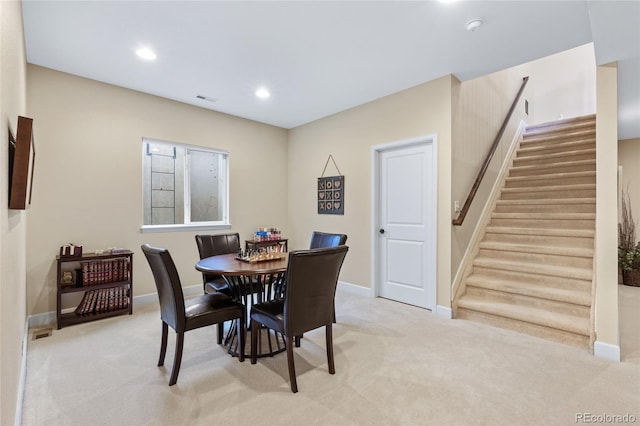 carpeted dining room featuring recessed lighting, visible vents, baseboards, and stairs