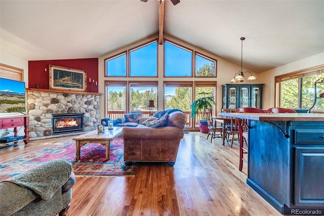 16 Thurber Ct, Fairplay, CO 80440 - living area with beam ceiling, high vaulted ceiling, wood finished floors, and a fireplace