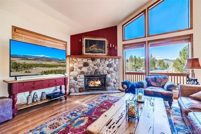 16 Thurber Ct, Fairplay, CO 80440 - living room featuring a mountain view, wood finished floors, a fireplace, and vaulted ceiling