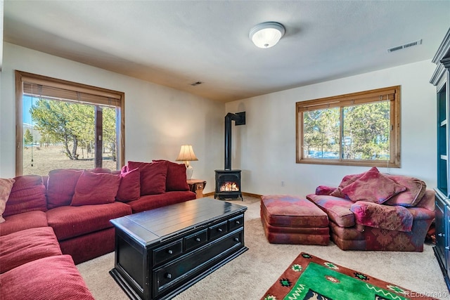 16 Thurber Ct, Fairplay, CO 80440 - living room with visible vents, baseboards, light colored carpet, and a wood stove