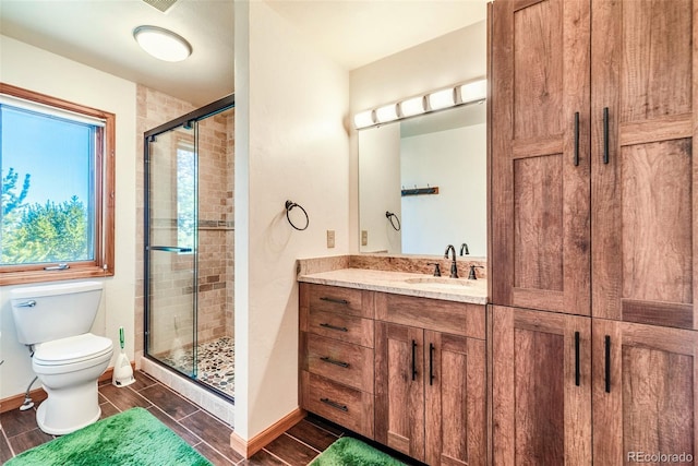 16 Thurber Ct, Fairplay, CO 80440 - bathroom with vanity, baseboards, wood finish floors, a stall shower, and toilet