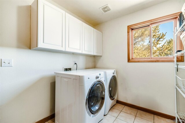 16 Thurber Ct, Fairplay, CO 80440 - washroom with visible vents, cabinet space, light tile patterned floors, baseboards, and washing machine and clothes dryer