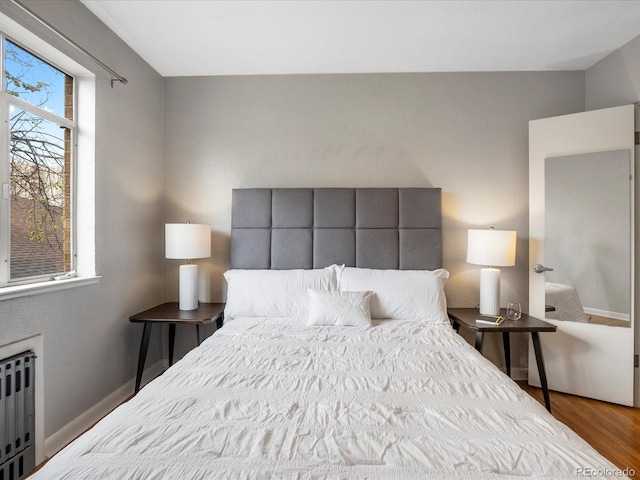 1130 N N Pennsylvania St Unit 306, Denver, CO 80203 - bedroom with radiator and wood finished floors