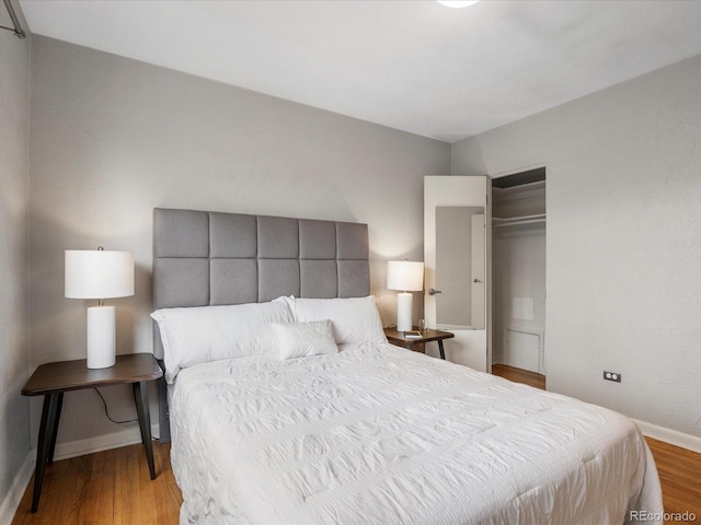 1130 N N Pennsylvania St Unit 306, Denver, CO 80203 - bedroom featuring wood finished floors and a closet