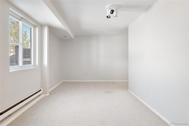 carpeted spare room with a baseboard radiator