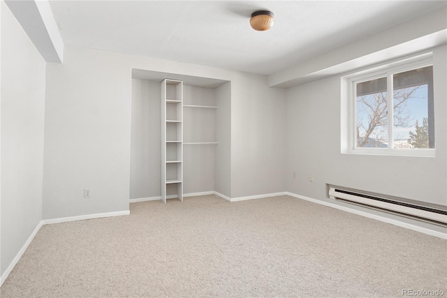 unfurnished bedroom featuring carpet flooring and a baseboard radiator