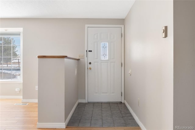 tiled foyer entrance featuring a wealth of natural light