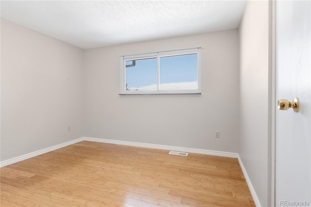 spare room featuring hardwood / wood-style flooring