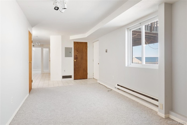 empty room with electric panel, light colored carpet, and a baseboard radiator