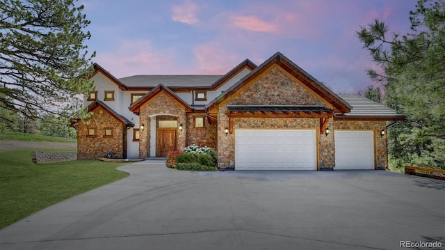 11790 Huckleberry Dr, Franktown, CO 80116 - view of front facade with concrete driveway, stone siding, a front lawn, and an attached garage