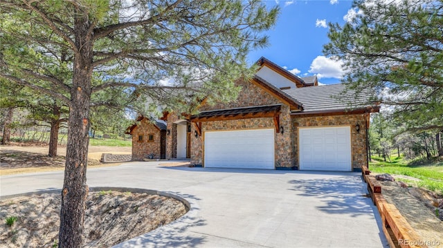 11790 Huckleberry Dr, Franktown, CO 80116 - view of front of property featuring driveway, stone siding, and an attached garage