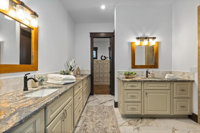 11790 Huckleberry Dr, Franktown, CO 80116 - bathroom featuring two vanities, marble finish floors, and recessed lighting