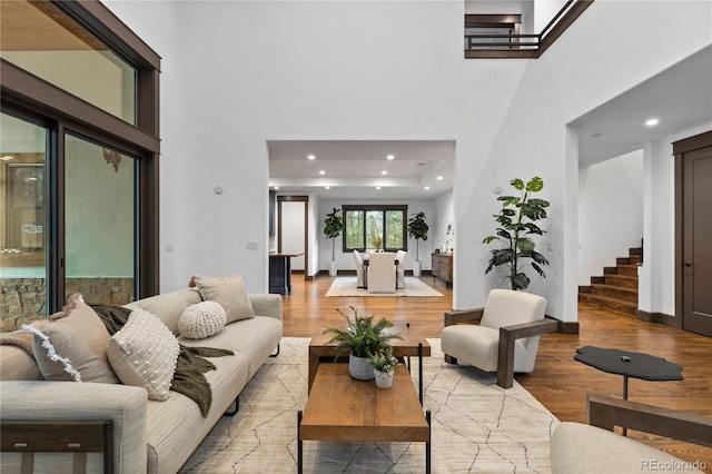 11790 Huckleberry Dr, Franktown, CO 80116 - living room with light wood-type flooring, a high ceiling, recessed lighting, and stairway
