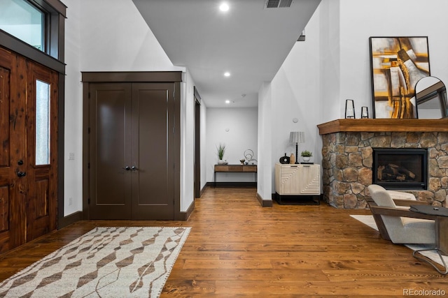 11790 Huckleberry Dr, Franktown, CO 80116 - foyer featuring wood finished floors, a stone fireplace, recessed lighting, and baseboards