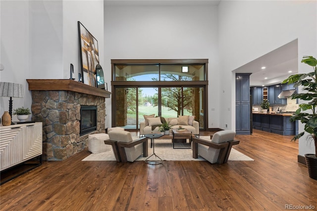 11790 Huckleberry Dr, Franktown, CO 80116 - living room featuring a towering ceiling, wood finished floors, a fireplace, baseboards, and recessed lighting