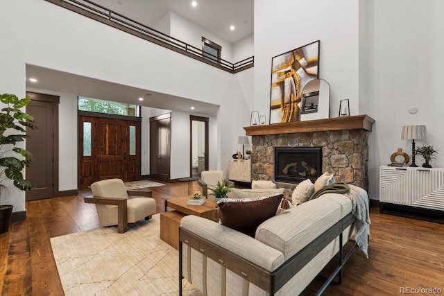 11790 Huckleberry Dr, Franktown, CO 80116 - living area featuring hardwood / wood-style flooring, a fireplace, baseboards, a towering ceiling, and recessed lighting
