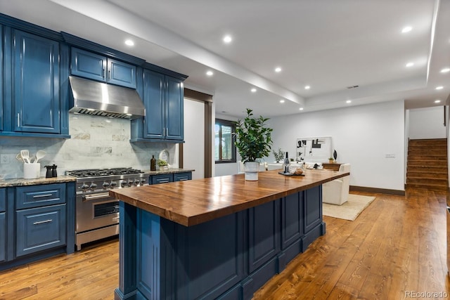 11790 Huckleberry Dr, Franktown, CO 80116 - kitchen featuring extractor fan, butcher block countertops, stainless steel range, blue cabinets, and light wood-type flooring