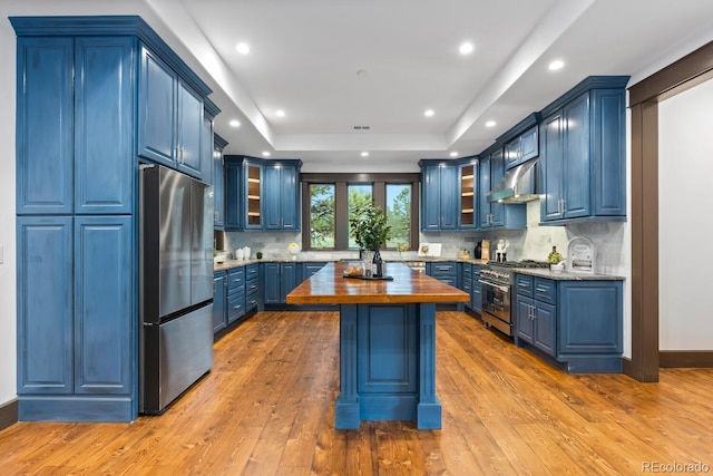 11790 Huckleberry Dr, Franktown, CO 80116 - kitchen featuring stainless steel appliances, blue cabinets, butcher block counters, range hood, and recessed lighting