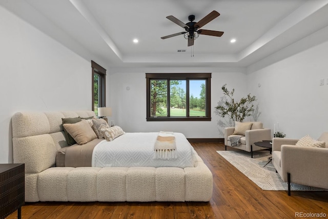 11790 Huckleberry Dr, Franktown, CO 80116 - bedroom featuring a tray ceiling, wood finished floors, recessed lighting, baseboards, and ceiling fan