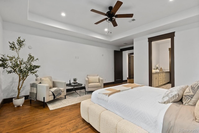 11790 Huckleberry Dr, Franktown, CO 80116 - bedroom featuring wood finished floors, a raised ceiling, recessed lighting, baseboards, and a ceiling fan