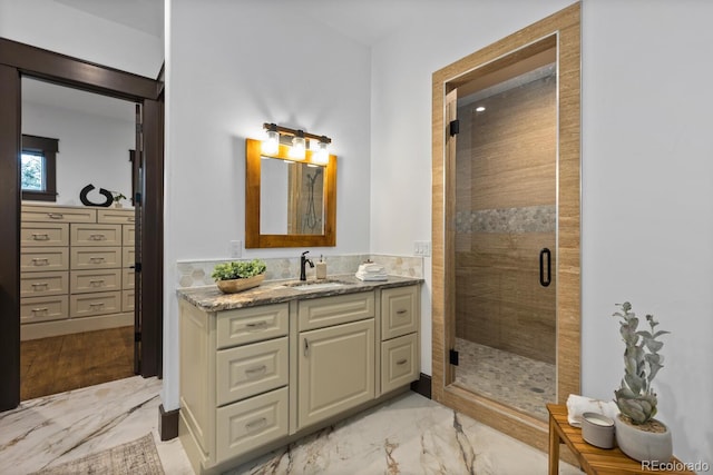 11790 Huckleberry Dr, Franktown, CO 80116 - bathroom featuring marble look tiles, vanity, and a stall shower