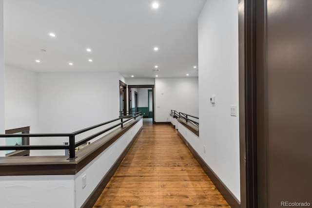 11790 Huckleberry Dr, Franktown, CO 80116 - hall featuring recessed lighting, an upstairs landing, wood finished floors, and baseboards