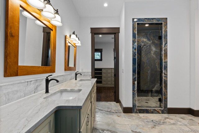 11790 Huckleberry Dr, Franktown, CO 80116 - bathroom with a marble finish shower, double vanity, marble finish floors, and recessed lighting