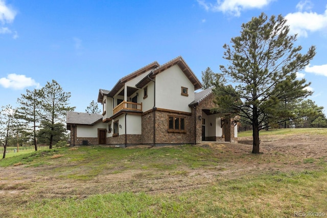 11790 Huckleberry Dr, Franktown, CO 80116 - back of house with a balcony, stucco siding, stone siding, and a lawn