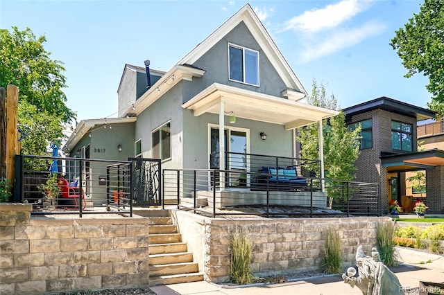 back of property with covered porch