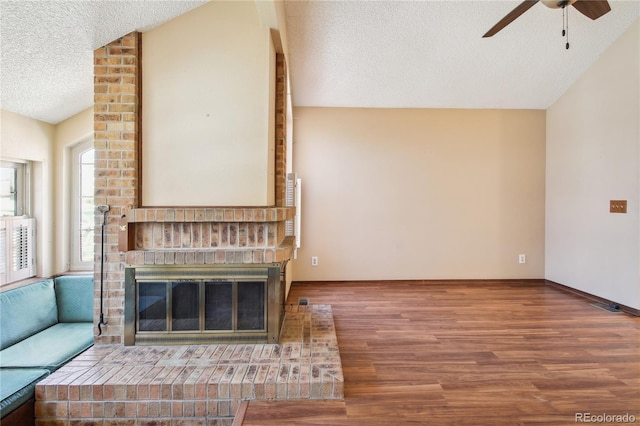 10262 W Ida Ave Unit 243, Littleton, CO 80127 - unfurnished living room featuring a textured ceiling, lofted ceiling, ceiling fan, and wood finished floors
