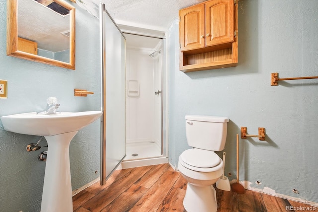 10262 W Ida Ave Unit 243, Littleton, CO 80127 - bathroom with wood finished floors, a stall shower, toilet, and a sink