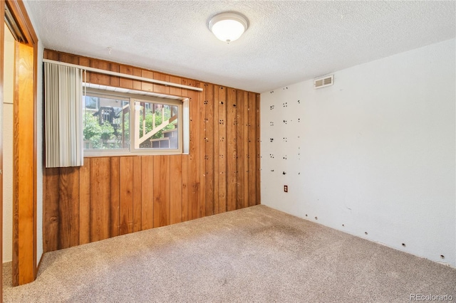 10262 W Ida Ave Unit 243, Littleton, CO 80127 - carpeted spare room featuring wooden walls and a textured ceiling