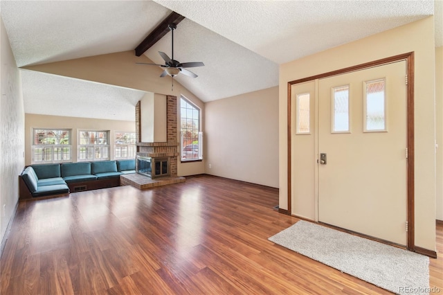 10262 W Ida Ave Unit 243, Littleton, CO 80127 - unfurnished living room featuring a fireplace, wood finished floors, a ceiling fan, and a textured ceiling