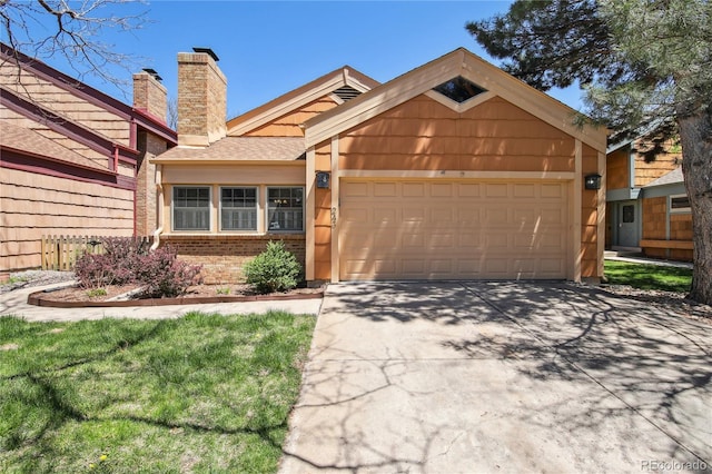 10262 W Ida Ave Unit 243, Littleton, CO 80127 - view of front of house with a garage, driveway, a chimney, and brick siding