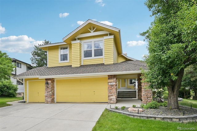 9385 Prairie View Dr, Highlands Ranch, CO 80126 - view of front of property with a garage, driveway, stone siding, a shingled roof, and a porch