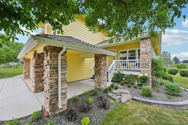 9385 Prairie View Dr, Highlands Ranch, CO 80126 - view of front of property featuring stone siding, roof with shingles, and a patio area