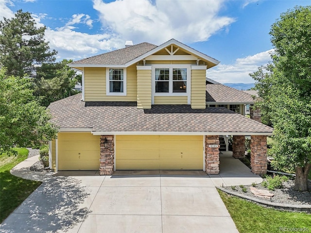 9385 Prairie View Dr, Highlands Ranch, CO 80126 - view of front of home featuring a shingled roof, stone siding, a garage, and driveway