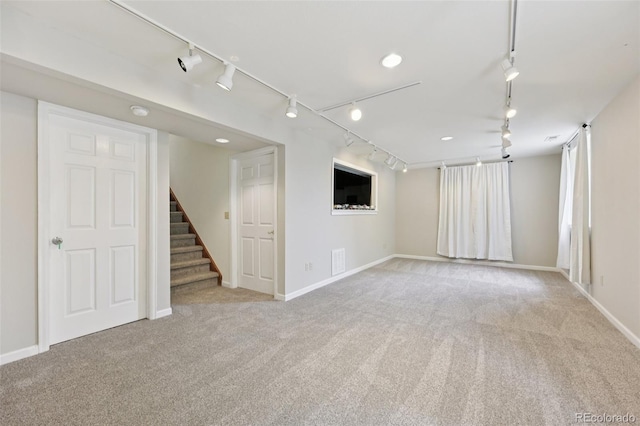 9385 Prairie View Dr, Highlands Ranch, CO 80126 - unfurnished room featuring rail lighting, carpet floors, and stairs