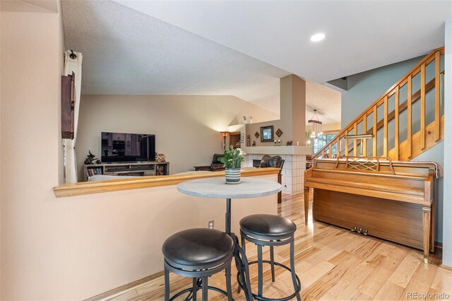 11313 Haswell Dr, Parker, CO 80134 - dining space with light wood finished floors, stairs, vaulted ceiling, and recessed lighting