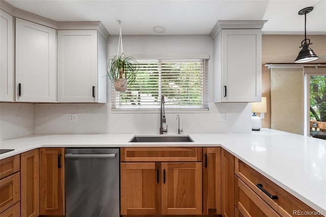 11313 Haswell Dr, Parker, CO 80134 - kitchen with stainless steel dishwasher, decorative backsplash, light countertops, and pendant lighting